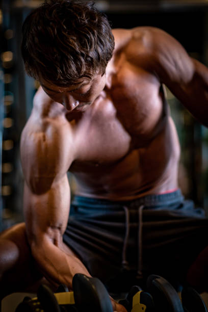 istock Mature man doing weight training in personal training gym 1171840276