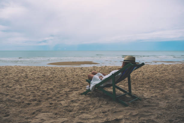 istock A woman fall asleep and lying down on a beach chair 1171841112