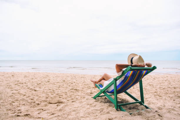 istock A woman lying down on a beach chair 1171841135