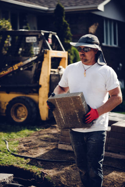 istock Construction worker renovating the front yard of a private house 1171842464