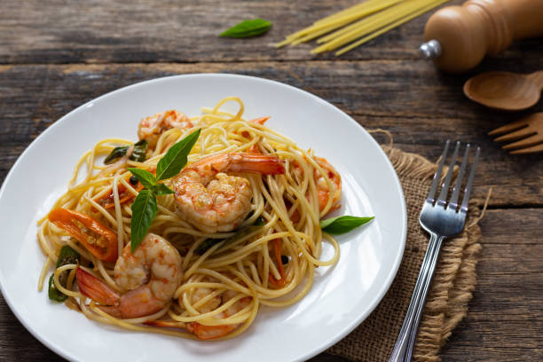istock Spaghetti with spicy fried shrimp on a wooden table 1171843054