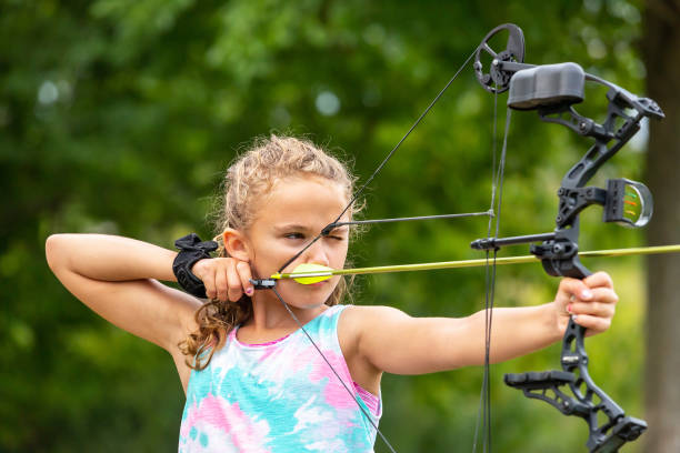 istock Young Girl Practicing Archery at Outdoor Shooting Range 1171847187