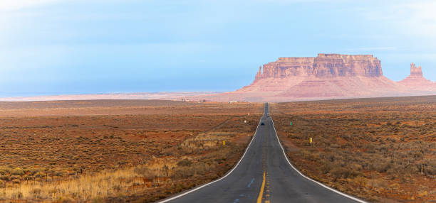 car driving on a highway in monument valley, new mexico, usa. extra-large stitched panorama. - monument valley usa panoramic imagens e fotografias de stock