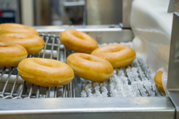 istock doughnuts or donut on conveyor belt in factory 1171849733