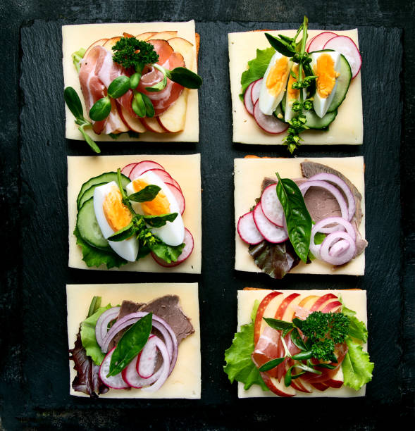Open faced sandwiches on black background