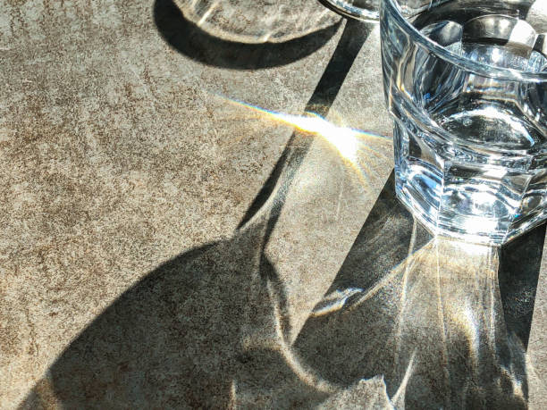 istock sunlight shine through glass. beautiful light and shadow on surface of table 1171859397