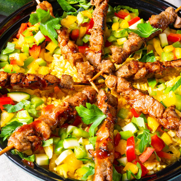 istock Lamb skewers with curry rice and different vegetables 1171859558