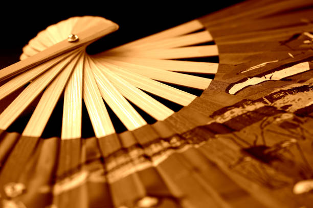istock Vietnamese fan spread out on a dark background close-up. Retro style 1171859748