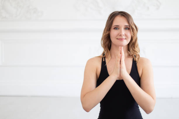istock Smiling woman meditates holding hands on her chest. Empty space for text 1171861926