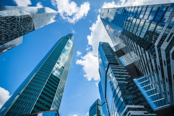 istock Business background. Modern office buildings under blue sky. 1171864240