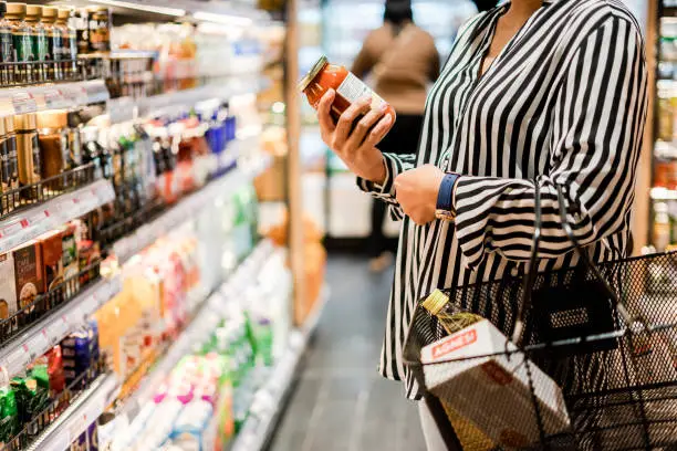 Photo of Bangkok, THAILAND - August 5, 2019: Woman chooses products in the supermarket, Ready-made food, Shopping .