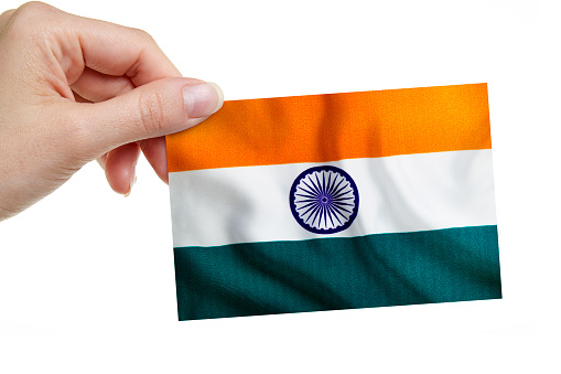 A woman is holding the Indian Flag on white background