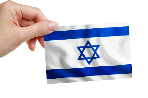 A woman is holding the Israeli Flag on white background