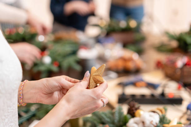 istock A star in a womans hand. Woman created a xmas arrangement. Master class on making decorative ornaments. Flower shop 1171871420