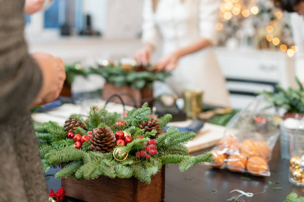 istock Christmas decor with their own hands. Woman created a xmas arrangement. Master class on making decorative ornaments. Flower shop 1171871559