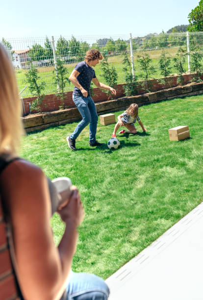 istock Mother watching her husband and son playing 1171872999