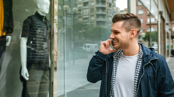 istock Man looking at the showcase of a store 1171874361