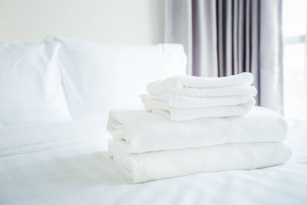 istock white towel on white bed in bed room 1171875466