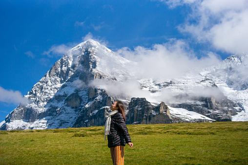 One young lady enjoying the beautiful scenery of Swiss alps