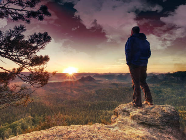 istock Man rest on mountain peak in background hills and clouds 1171875553
