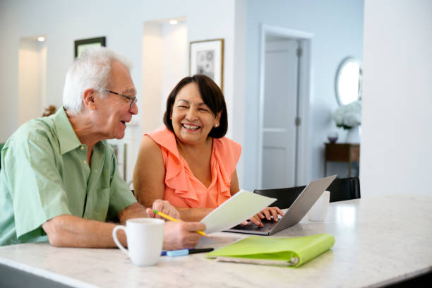 istock Lighthearted Latin American senior couple working on home finances 1171876659