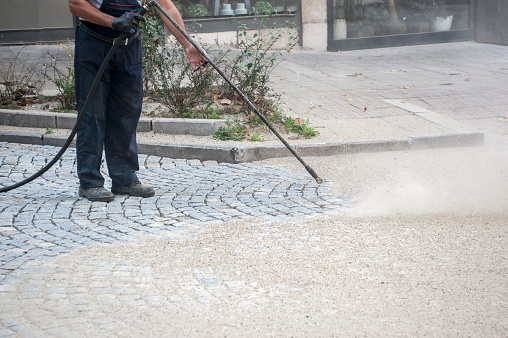 worker, cleaning the streets with a breeze of air