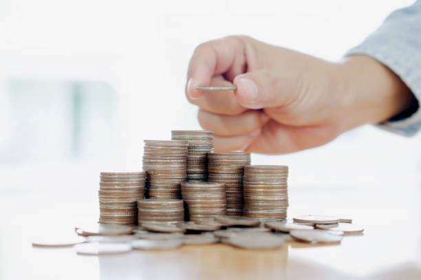 istock Hand giving coins into stack, business and finance concept 1171878522