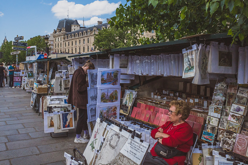 June 14, 2019 - Paris, France: Book and art sellers' stands on street by Seine in downtown Paris