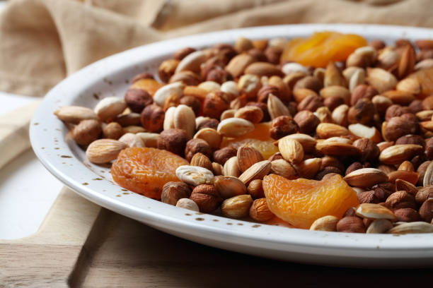 Hazelnuts, peeled apricot kernels and dried apricots on a platter