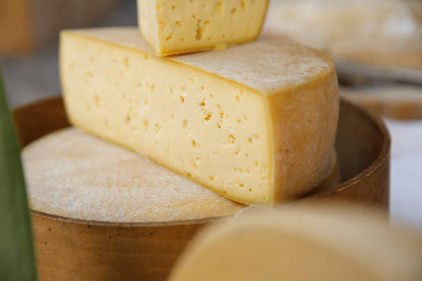 istock Parmesan cheese cut in half on wood plate. 1171885630