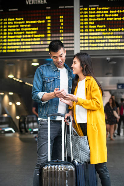 istock Couple navigating on the mobile phone at the Antwerp Central train station 1171885819