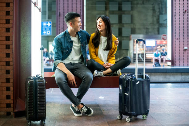 istock Couple looking at each other while waiting for train 1171885826