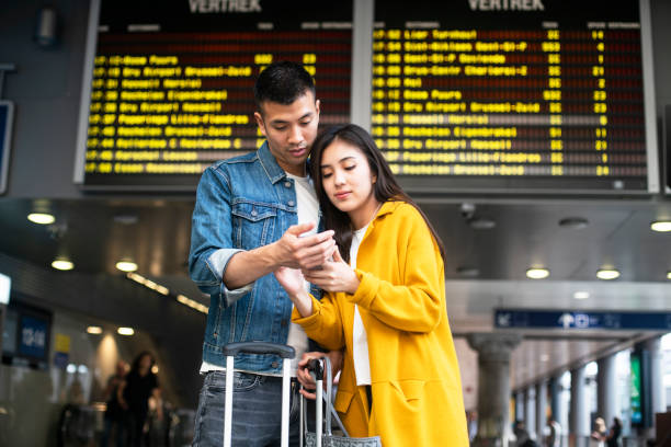 istock Couple navigating on the mobile phone at the Antwerp Central train station 1171886395