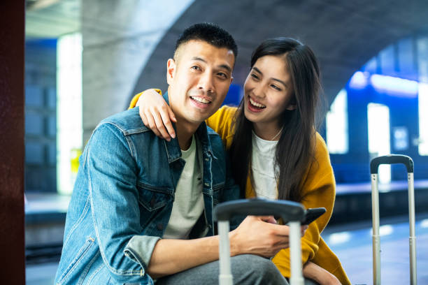 istock Happy couple at the train station 1171886399