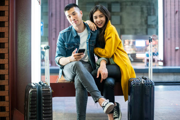 istock Couple sitting at the train platform 1171887042