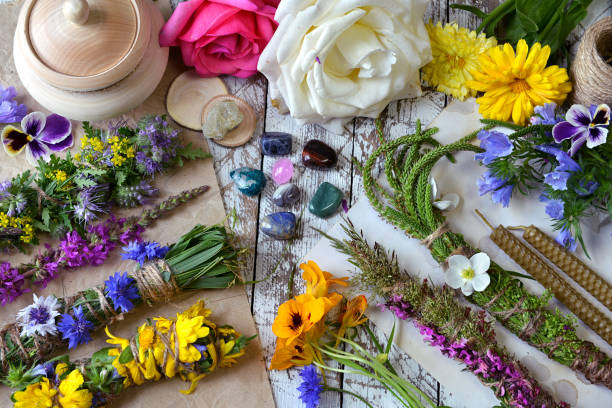 istock Top view of witchery scrolls with magic herbs, summer flowers and crystals on table. 1171889526
