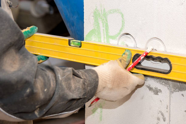 istock Hands Builder measure the level of the wall in the house under construction 1171890975