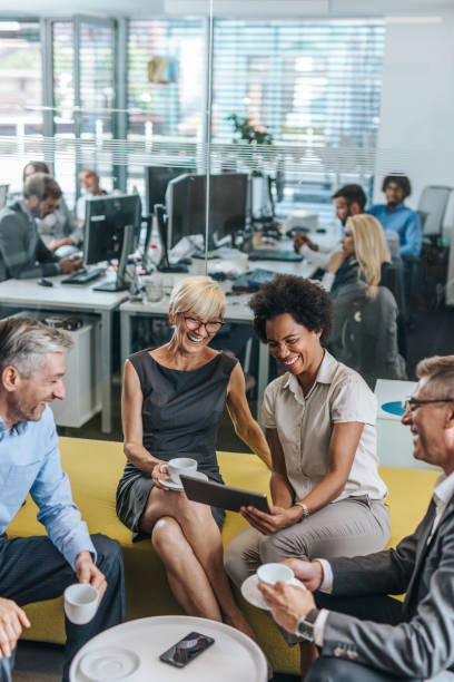istock Cheerful business people using digital tablet on coffee break. 1171891862