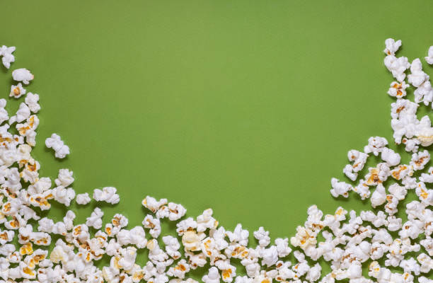istock White tasty popcorn on a green background. Popcorn pattern on green background. Top view. Copyspace for your text. 1171893139