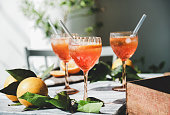 Spritz cocktail in glasses with fresh oranges