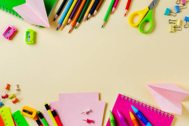 istock Notebook, colored pencils, ruler, pen, eraser, sharpener and more. School and office stationery on yellow background. Concept back to school. Top view. 1171895013