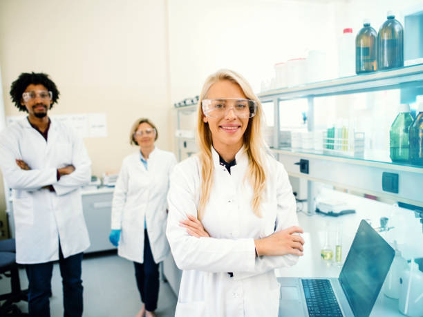 istock Team of smiling chemists in a laboratory 1171895103