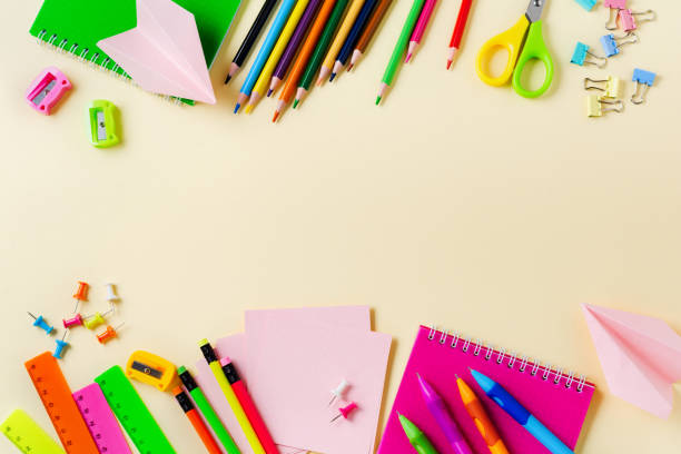 istock Notebook, colored pencils, ruler, pen, eraser, sharpener and more. School and office stationery on yellow background. Concept back to school. Top view. 1171895118