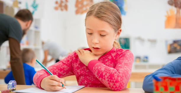 istock Girl writing in her notebook at school 1171896598