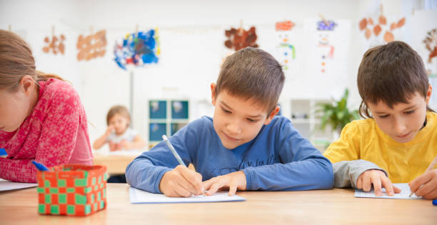 istock Children writing in their notebooks at school 1171896606