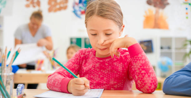 istock Girl writing in her notebook at school 1171896613