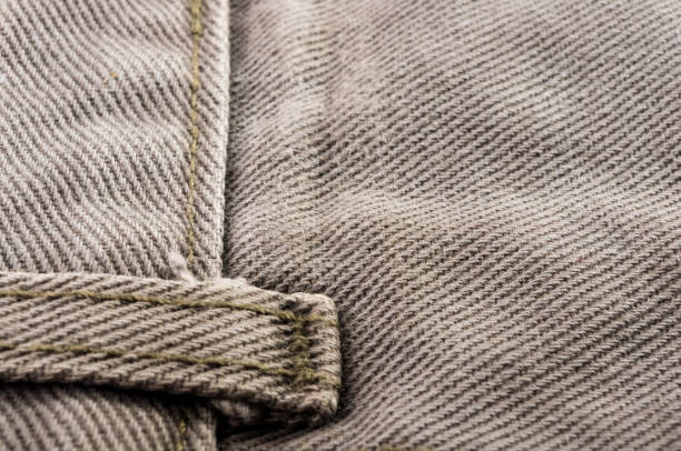 istock clothing items stonewashed cotton fabric texture with seams, clasps, buttons and rivets, macro 1171896890