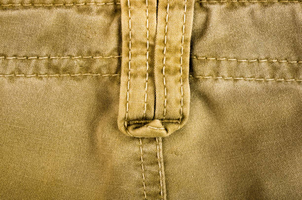 istock clothing items stonewashed cotton fabric texture with seams, clasps, buttons and rivets, macro 1171896965