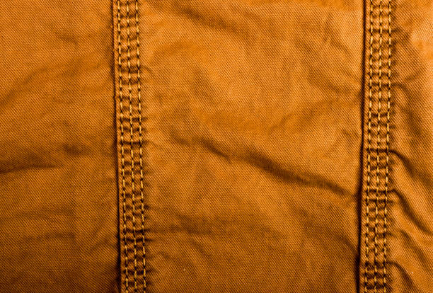 istock clothing items stonewashed cotton fabric texture with seams, clasps, buttons and rivets, macro 1171898764