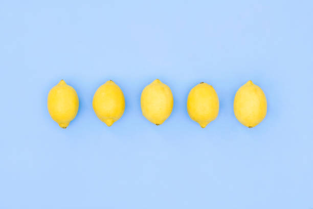 Lemons on blue background with copy space for your text. Flat lay, top view.